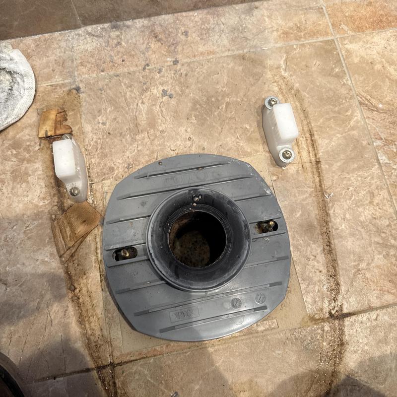 Toilet flange installation on tiled bathroom floor
