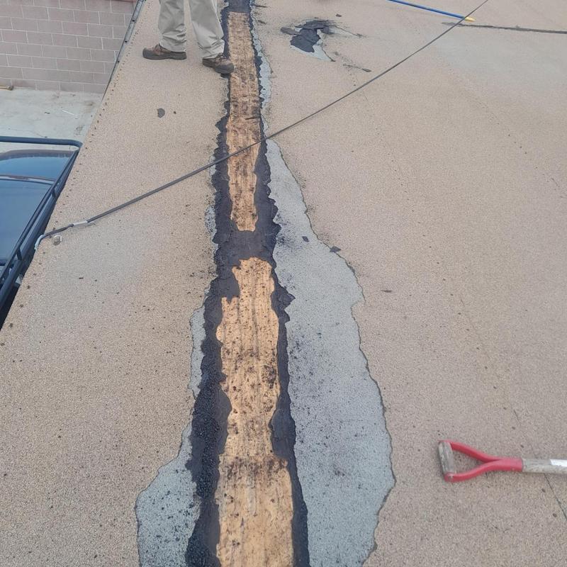 Flat roof membrane strip removal with tools and worker Flat roof membrane strip removal with tools and worker