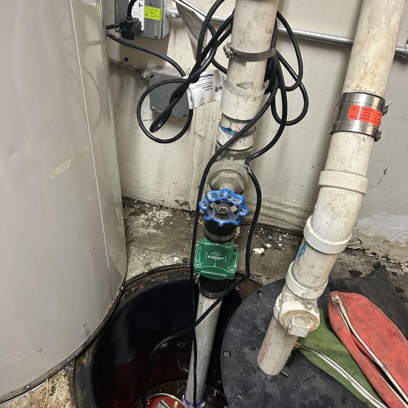 Sump pump system with valve and wiring in basement