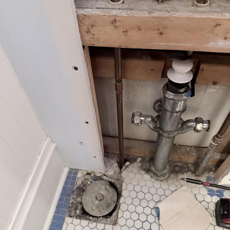 Tub drain pipe and trap with access panel removed Tub drain pipe and trap with access panel removed