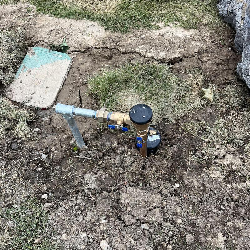 Backflow preventer valve and water meter box outdoors