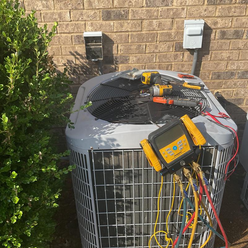 Condenser unit with diagnostic gauges and tools outdoors Condenser unit with diagnostic gauges and tools outdoors