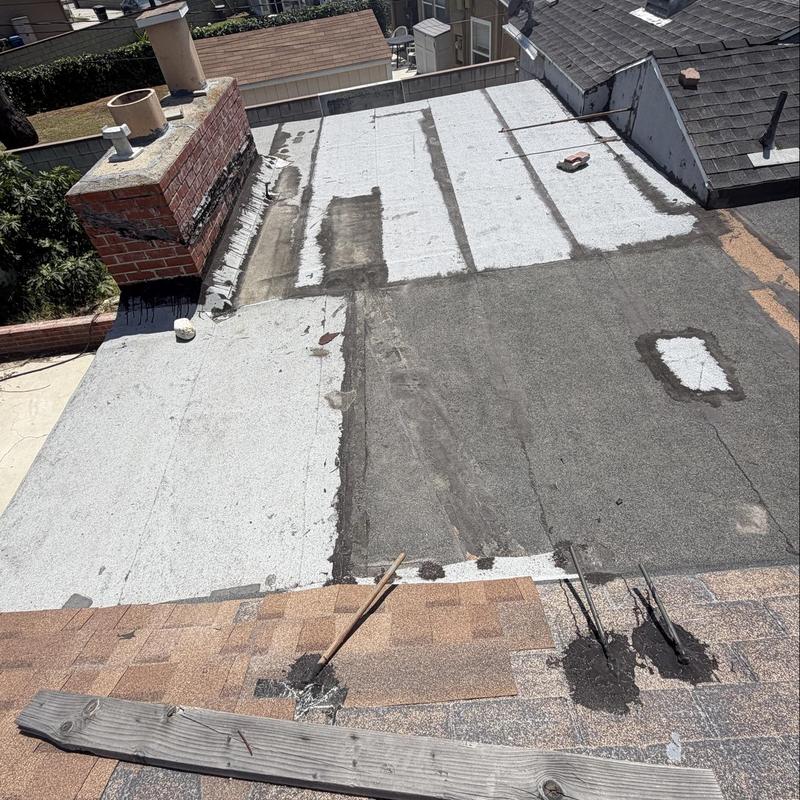 Torch down flat roof membrane with patch repairs Torch down flat roof membrane with patch repairs