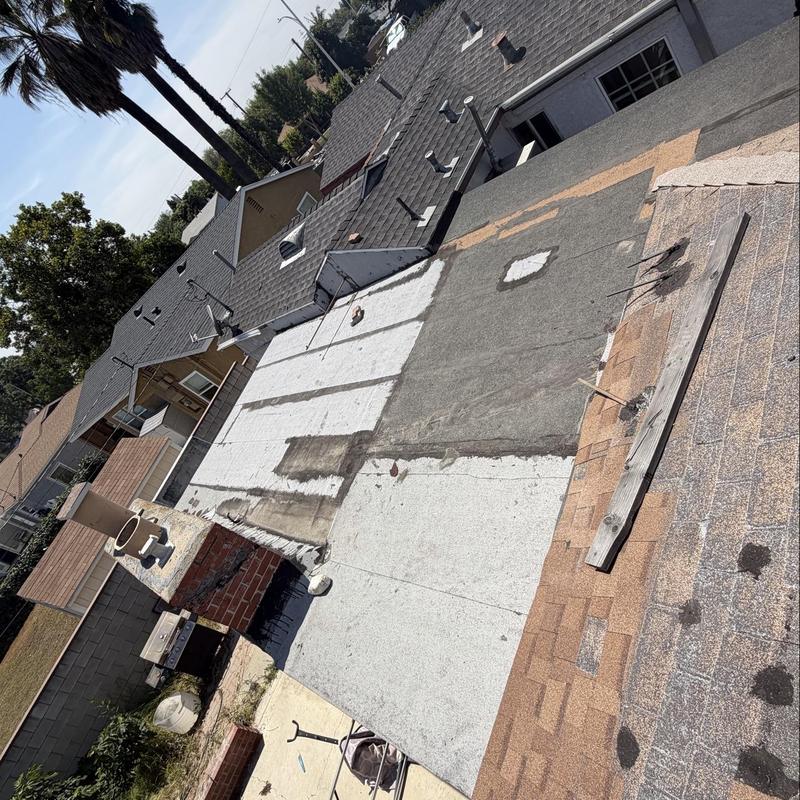Torch down flat roofing membrane with patch repairs Torch down flat roofing membrane with patch repairs