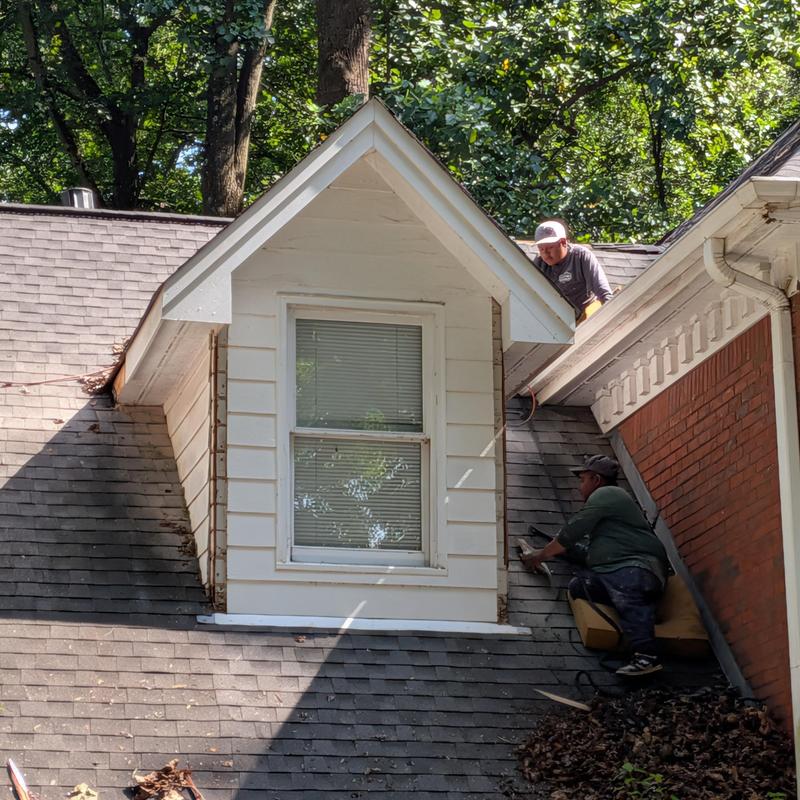 Dormer corner boards repair with workers on roof