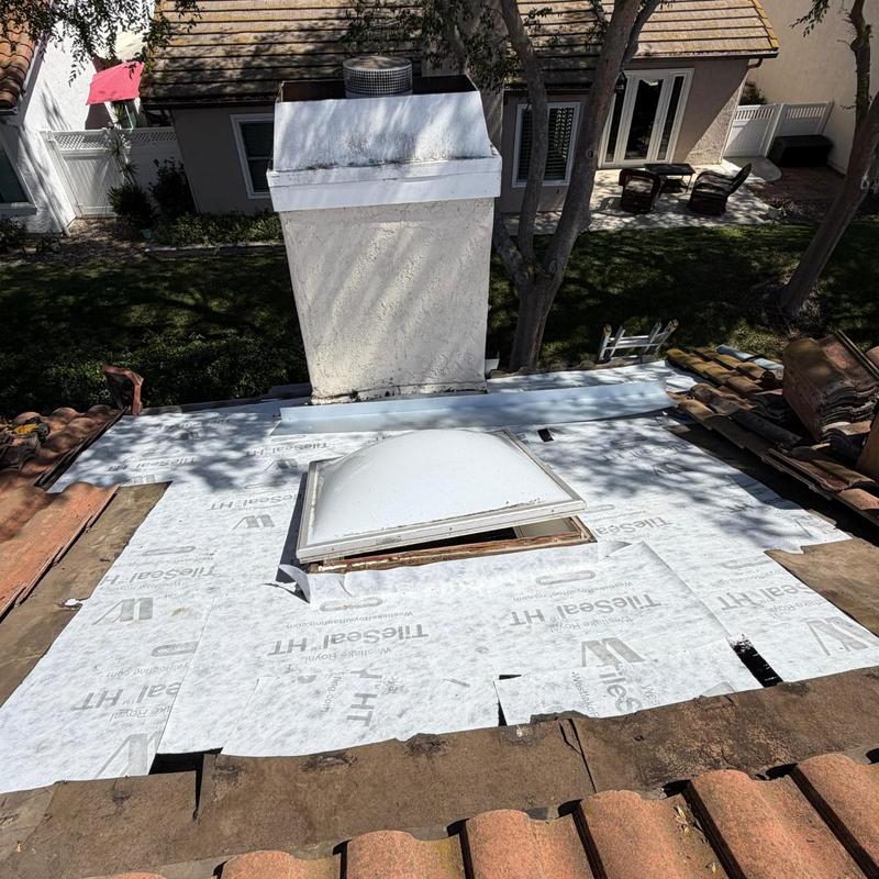 Roof skylight underlayment installation with chimney nearby Roof skylight underlayment installation with chimney nearby