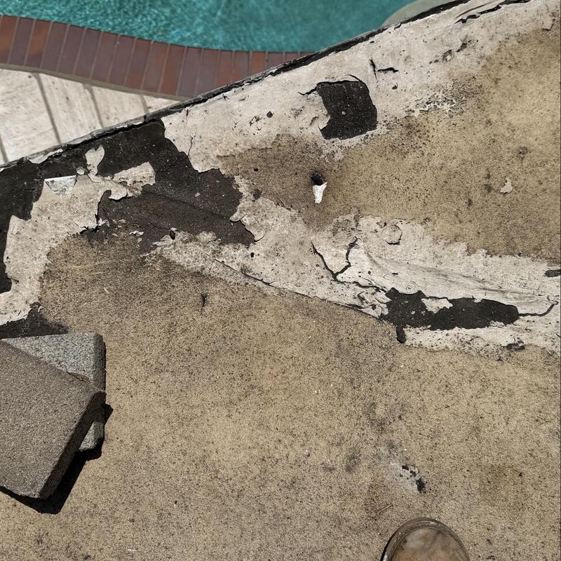 Flat roof surface with peeling and damage near pool Flat roof surface with peeling and damage near pool