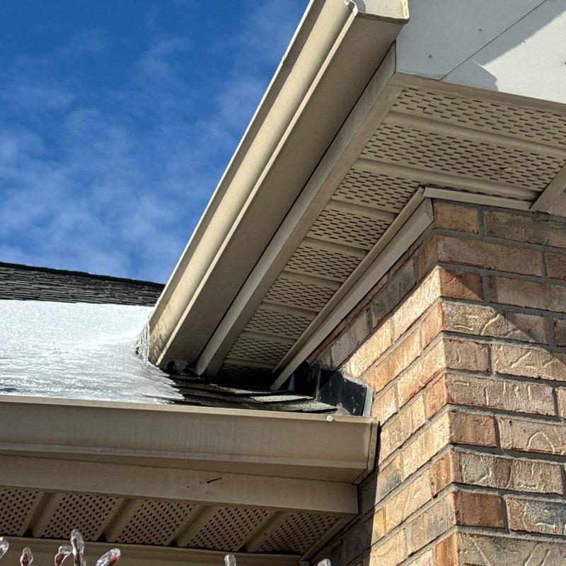 Gutter and soffit system on brick exterior with ice buildup