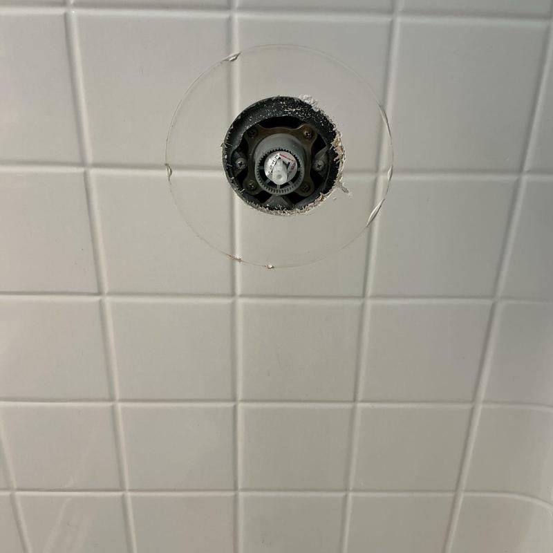 Shower cartridge housing in tiled bathroom wall