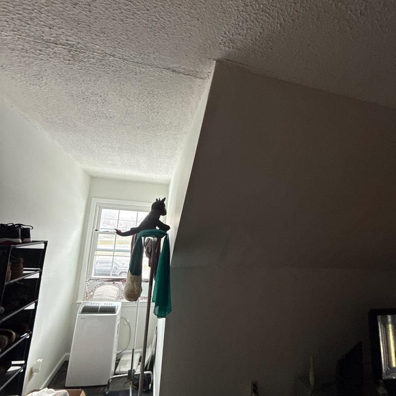 Popcorn ceiling water stain near window alcove