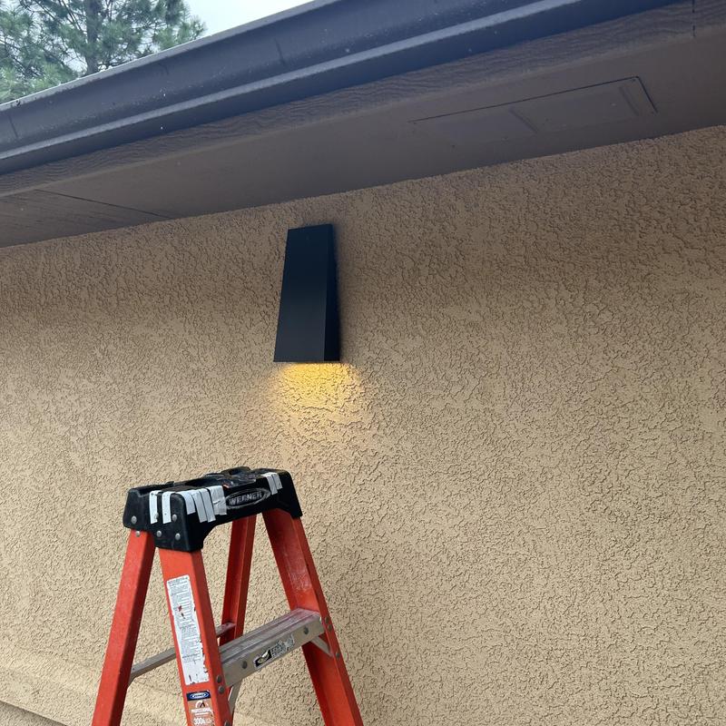 Outdoor wall light fixture installation with ladder