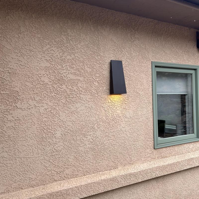 Outdoor wall light fixture installation by window