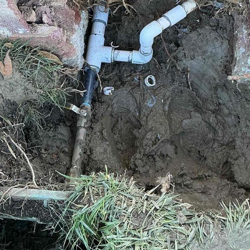 1-1/4 PVC piping and fittings in muddy excavation