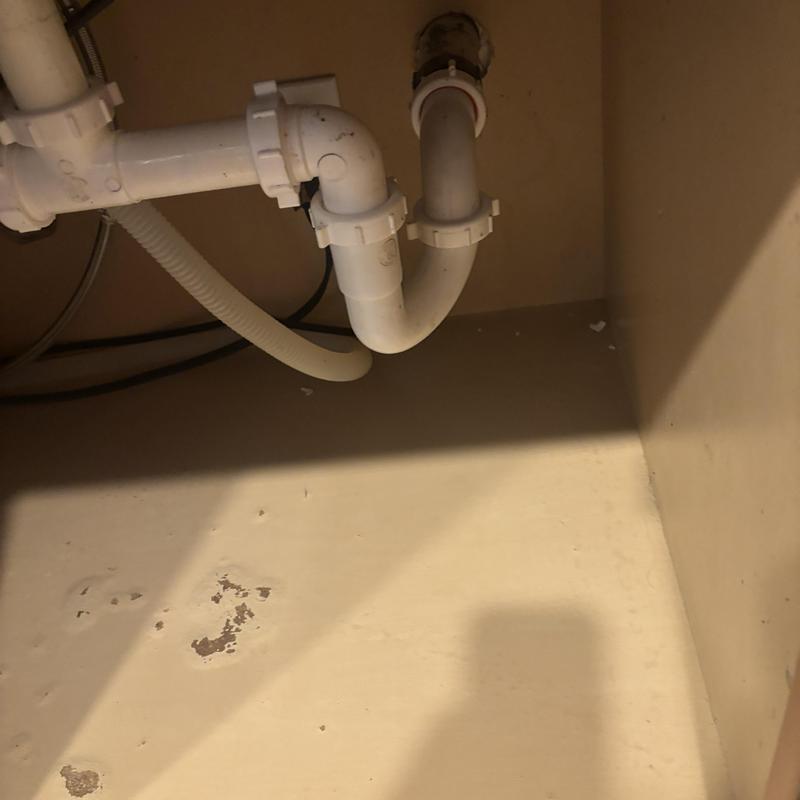 Kitchen sink drain pipes and trap under cabinet