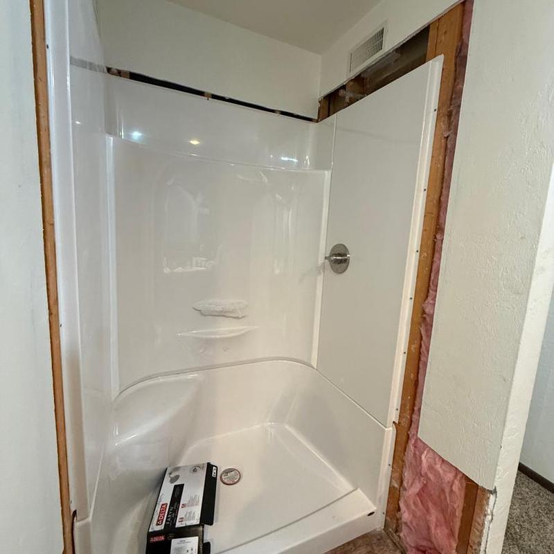 48x32 white 3-piece shower installation in progress 48x32 white 3-piece shower installation in progress