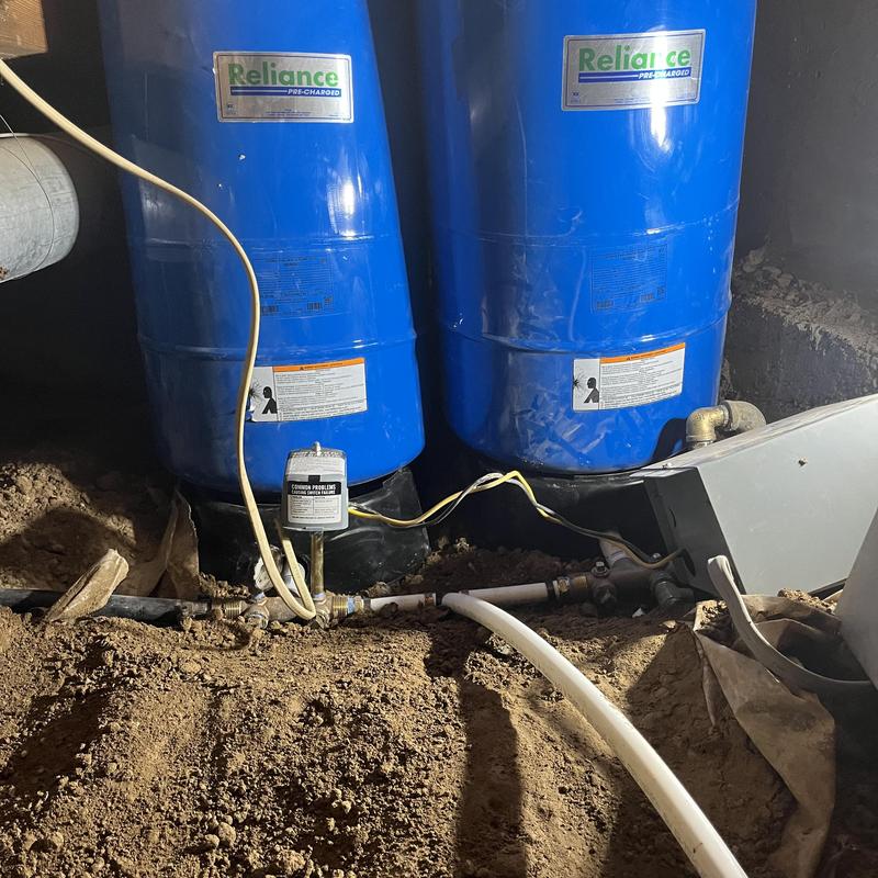 Well pressure tanks installation in crawl space