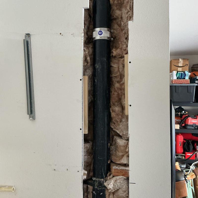 ABS drain pipe with Husky band repair in wall cavity