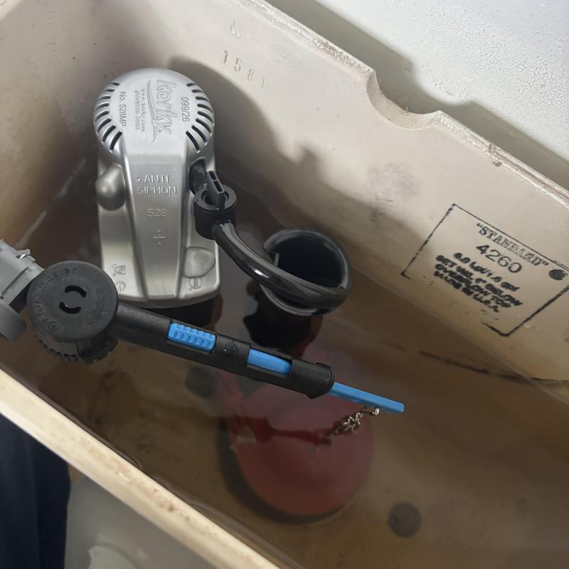 Toilet fill valve and flapper inside tank