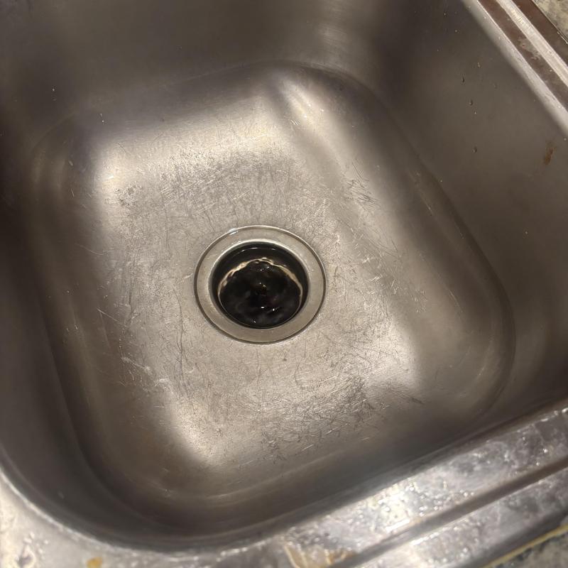 Kitchen sink drain with clean stainless steel basin