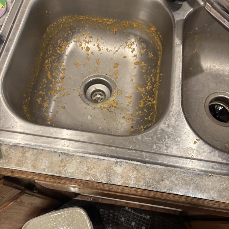 Kitchen sink with grease residue before cleaning