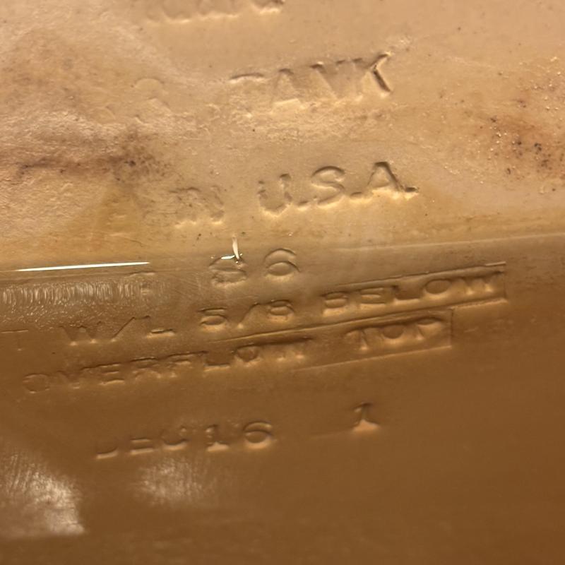 American Standard toilet tank lid with embossed text