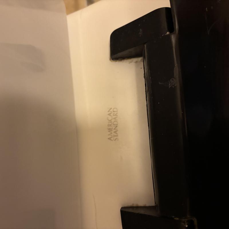 American Standard toilet lid with black hinge component