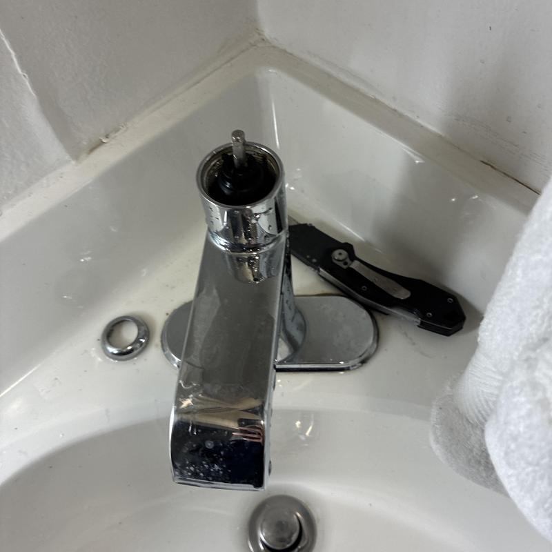Bathroom sink faucet removal and replacement in progress