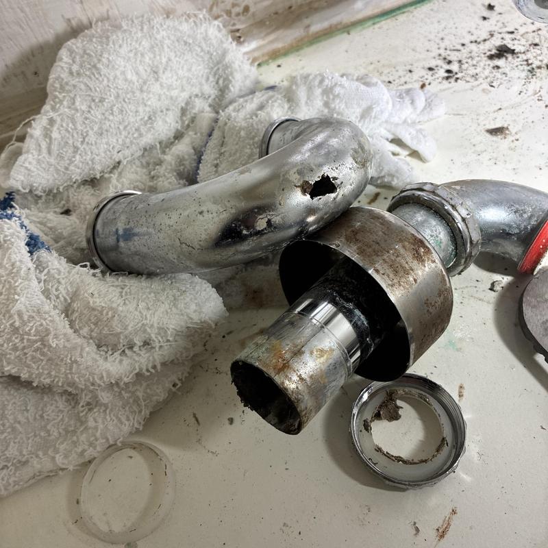 P-trap pipe with corrosion hole removed for replacement