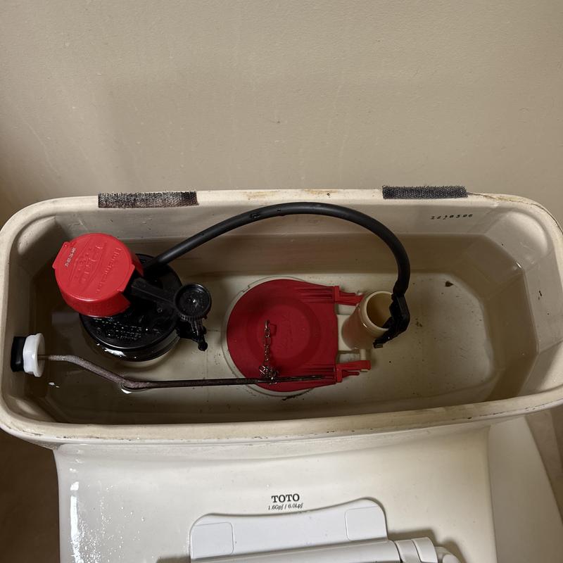 Toilet fill valve and flapper inside tank