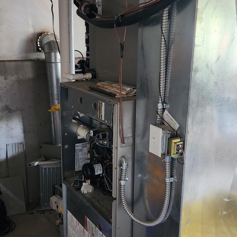 Furnace unit with open panel and wiring visible