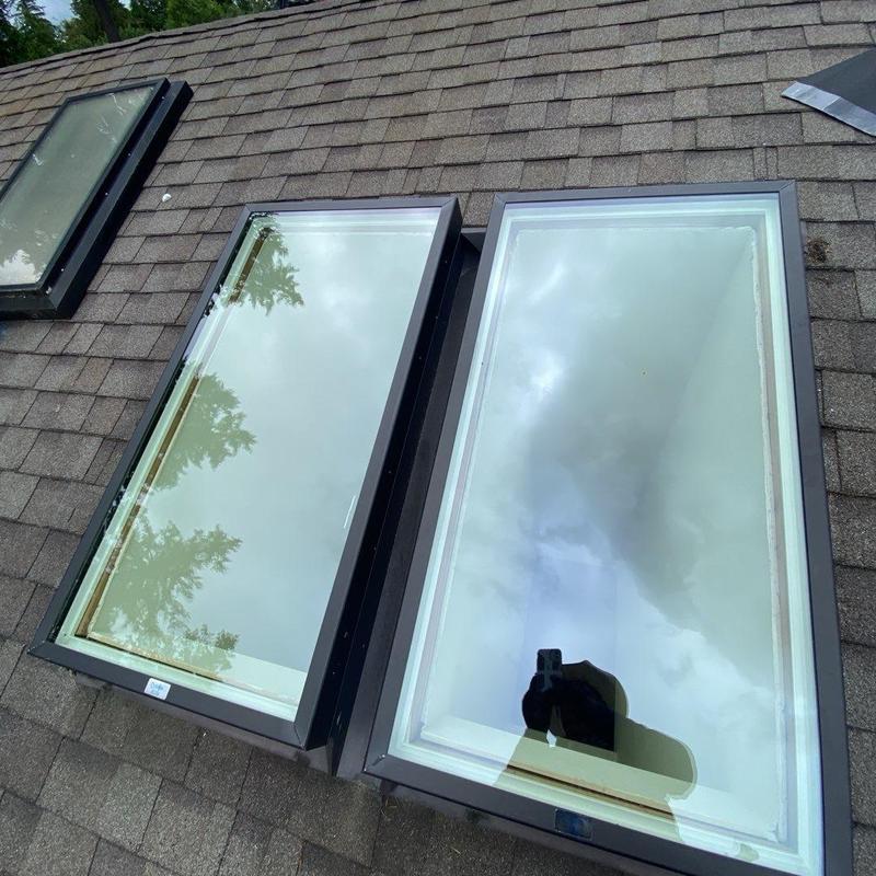 Skylight glass panels on asphalt shingle roof