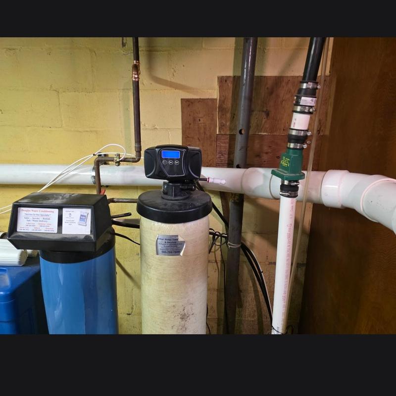 Water softener system with control valve and plumbing pipes