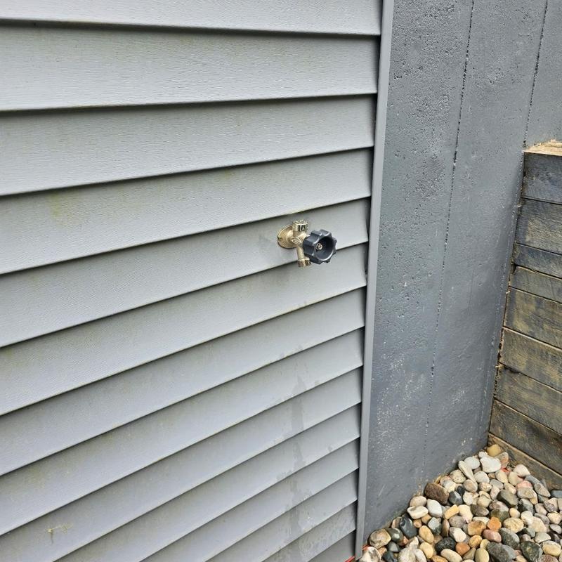 Frost-free outdoor spigot installed on siding wall