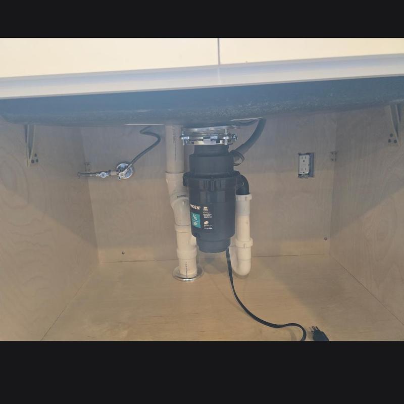 Garbage disposal and plumbing under kitchen sink installation
