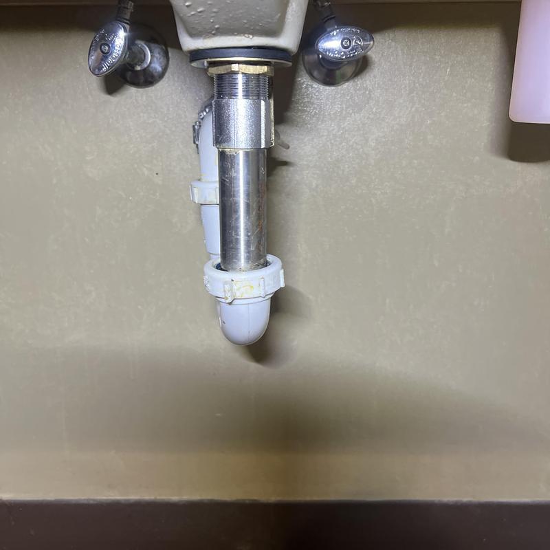 Kitchen sink drain pipe with fittings under cabinet