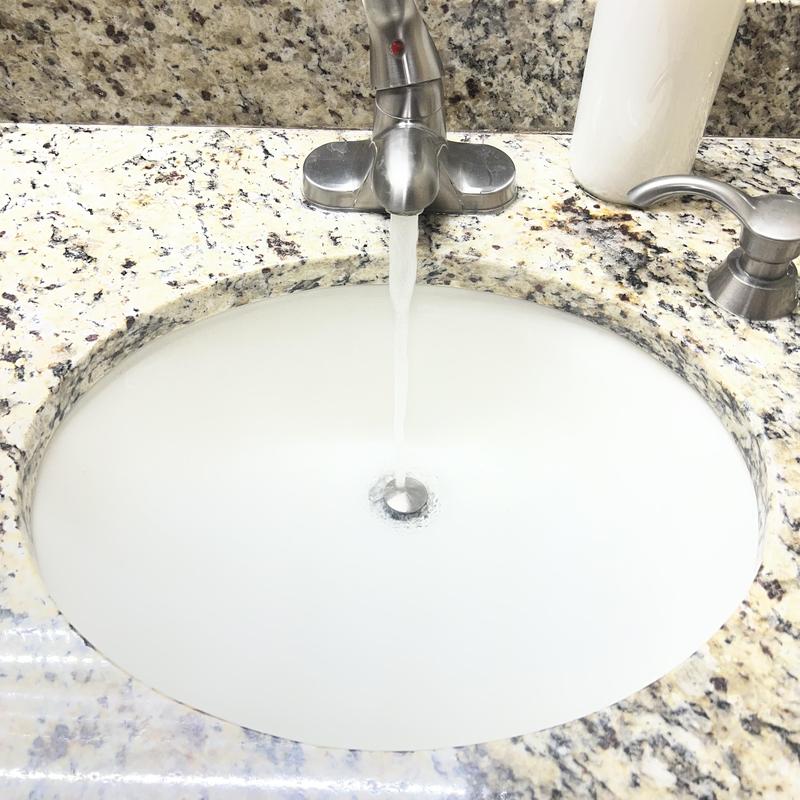 Bathroom sink drain flow with running water
