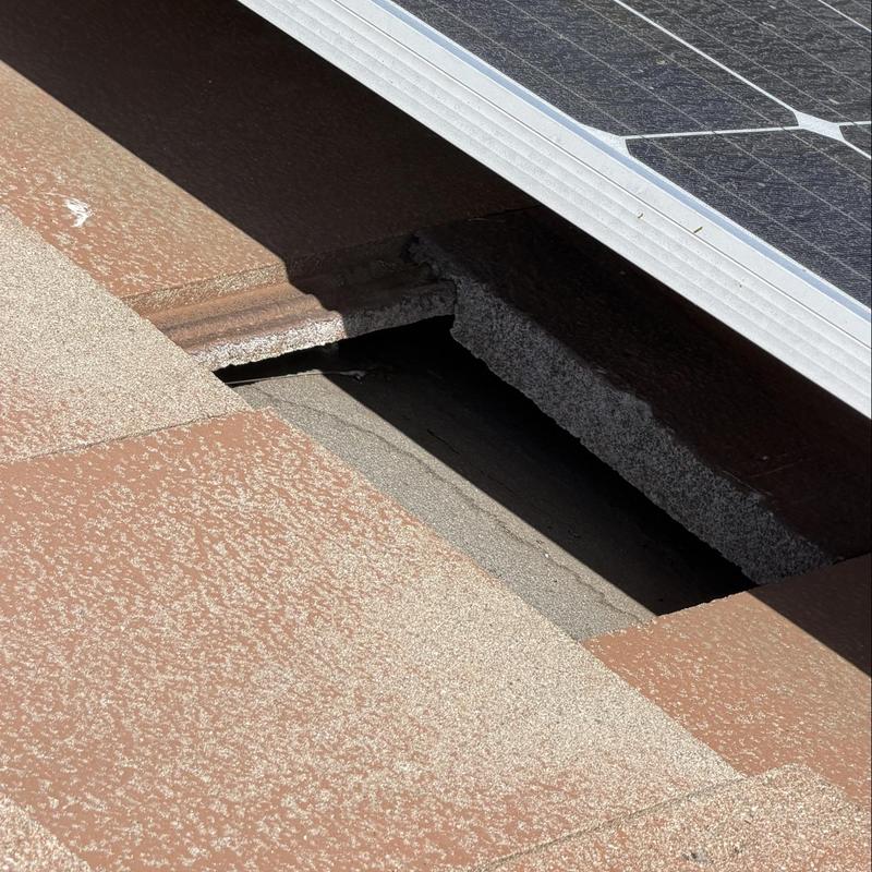 Flat tile roof with solar panel edge detail Flat tile roof with solar panel edge detail