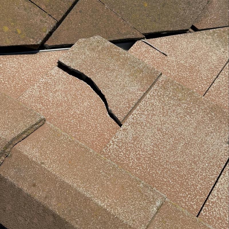 Flat tile roofing with visible cracks and damage Flat tile roofing with visible cracks and damage