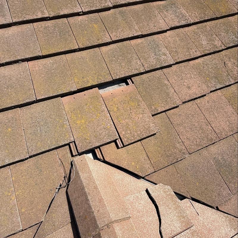 Flat tile roof with displaced and cracked tiles Flat tile roof with displaced and cracked tiles