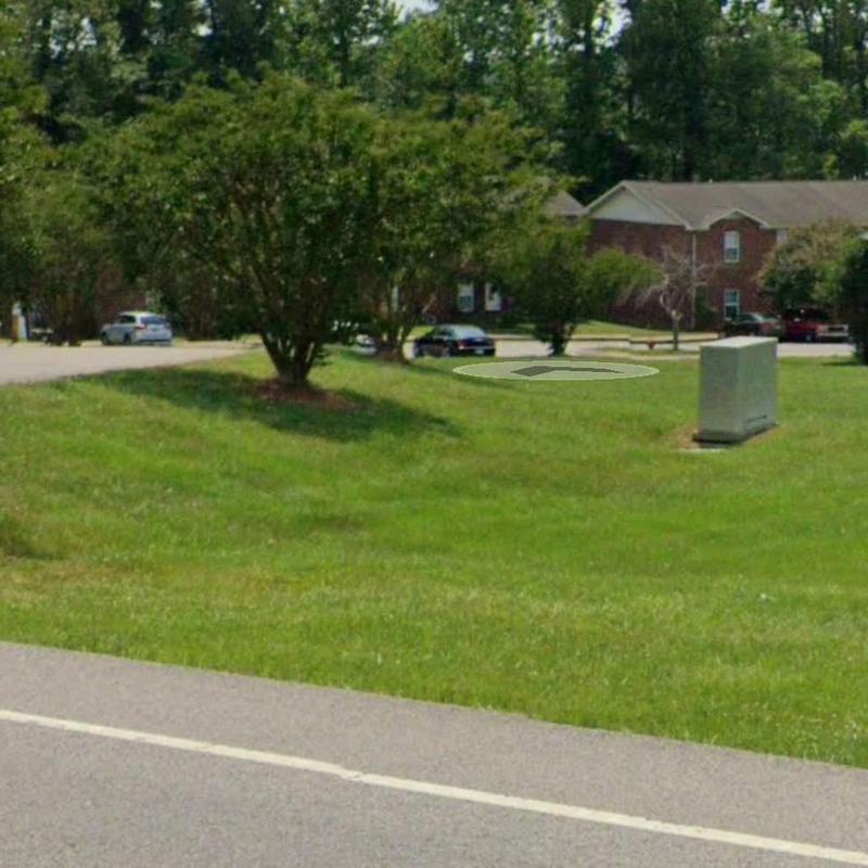 Utility box on grassy area near residential buildings