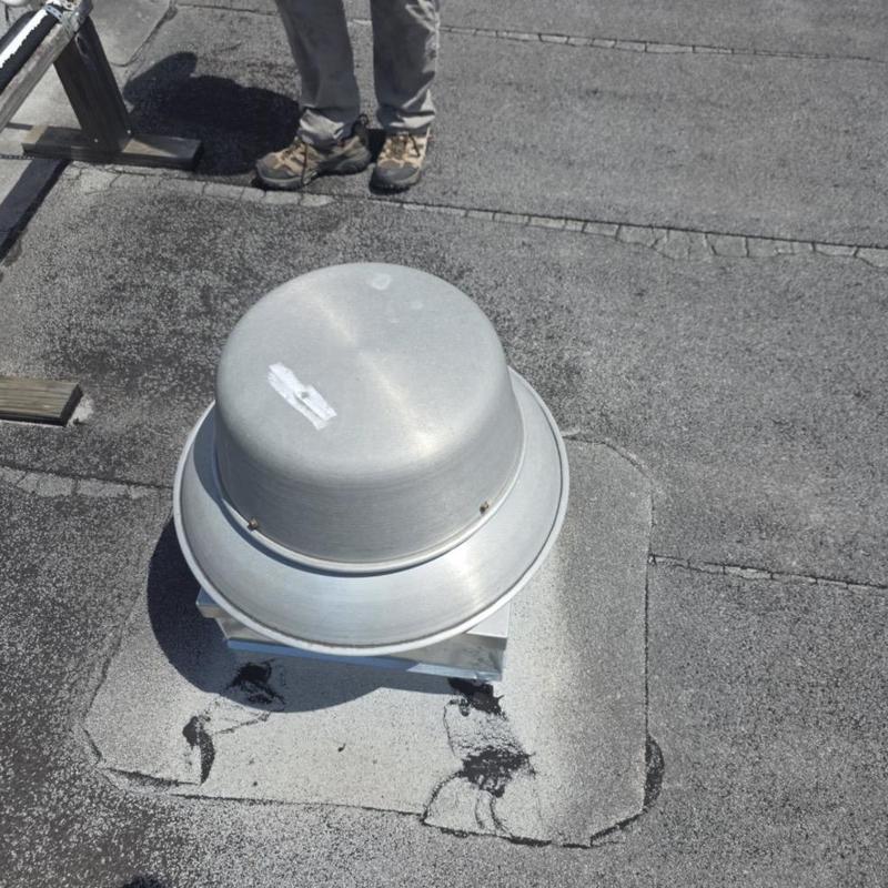 Rooftop metal vent on modified bitumen roof
