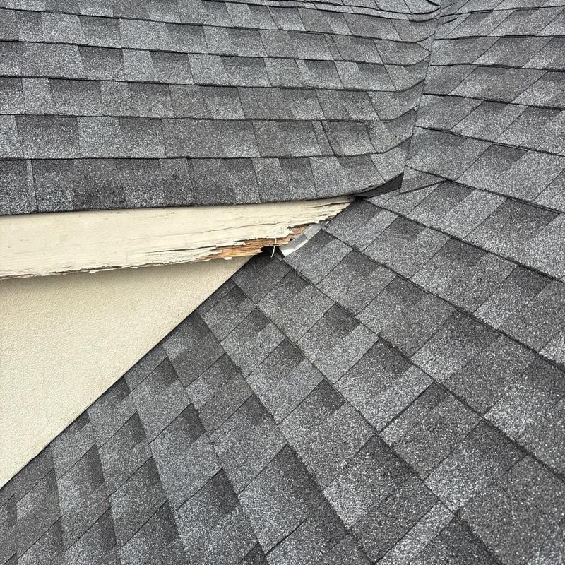Roof shingles and wood fascia damage at roof valley