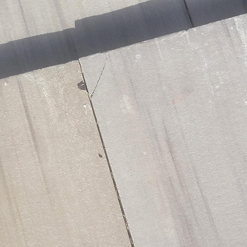 Concrete tile roof with visible crack defect