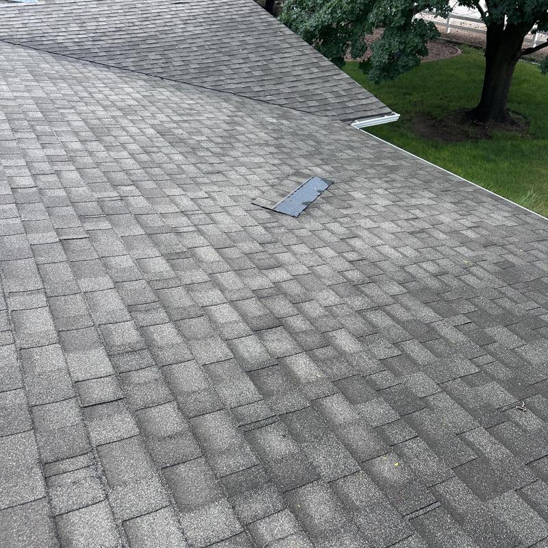 Asphalt shingle roof with patch repair near vent