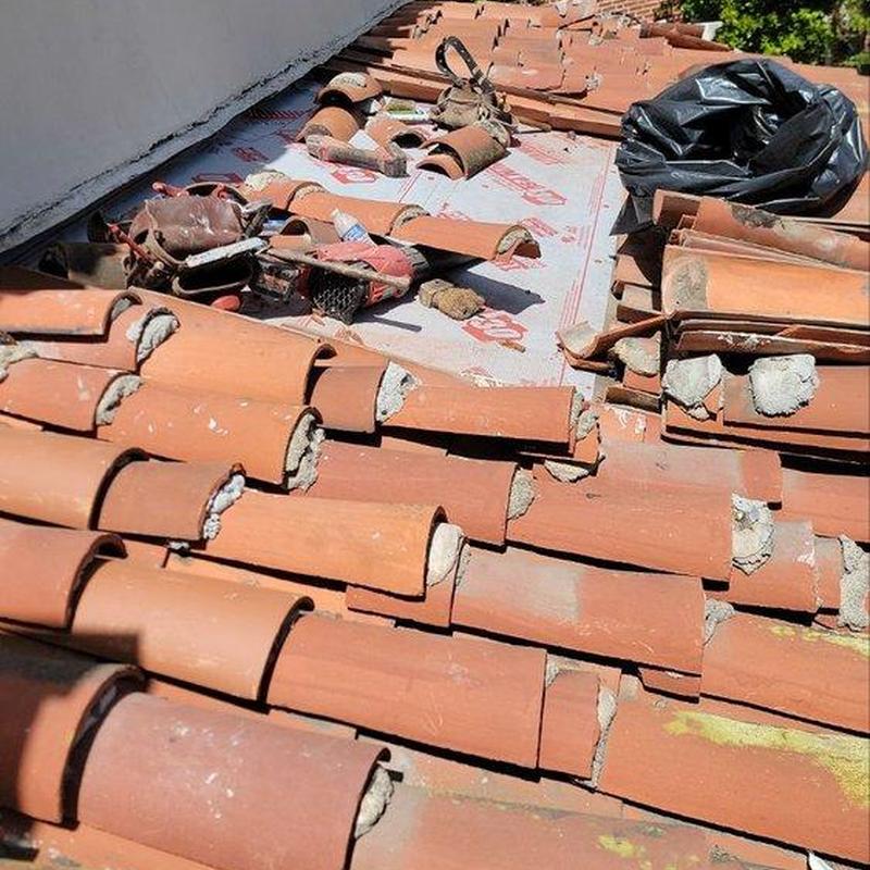Tile roofing with repair materials and tools laid out Tile roofing with repair materials and tools laid out