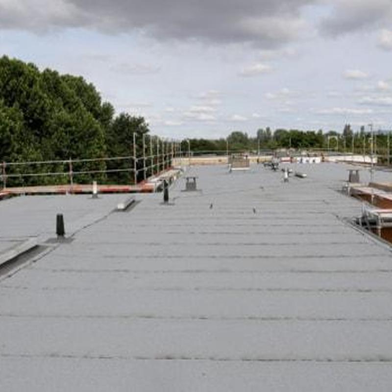 Flat roof membrane installation with safety railing Flat roof membrane installation with safety railing
