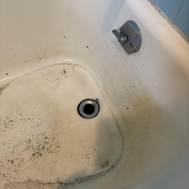 Tub drain with dirt and debris buildup Tub drain with dirt and debris buildup