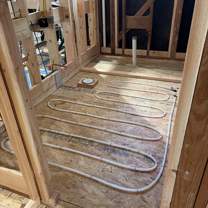 Radiant heating tubing installed on subfloor