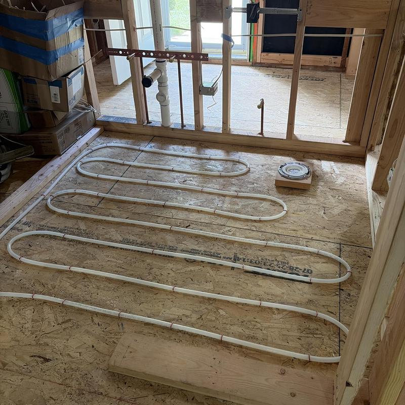 Radiant heating tubing installation on subfloor