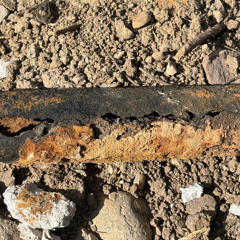 Cast iron drain pipe with severe rust and holes